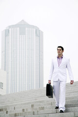 Businessman with briefcase walking down the stairs