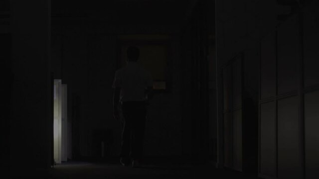 Security Guard makes a detour In Corridor Of The Building Using Flashlight. High-quality 4k footage