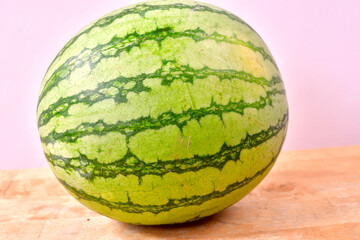 Freesh juicy watermelon sitting on a wooden table..