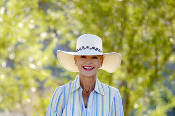 Woman with hat smiling at the camera