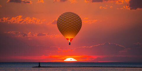 The colorful sunset at the Great Van Lake - Colorful hot air balloon flying over Van lake at red sunset