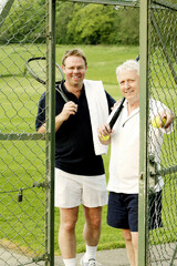 Two men with tennis racquet and tennis ball