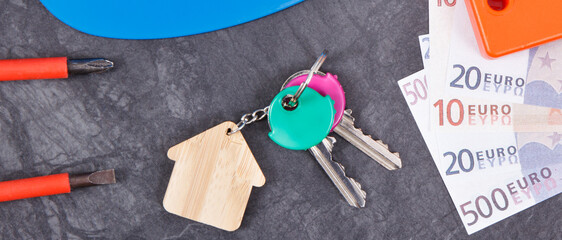 Keys with house shape, currencies euro and work tools for engineering work. Building home concept