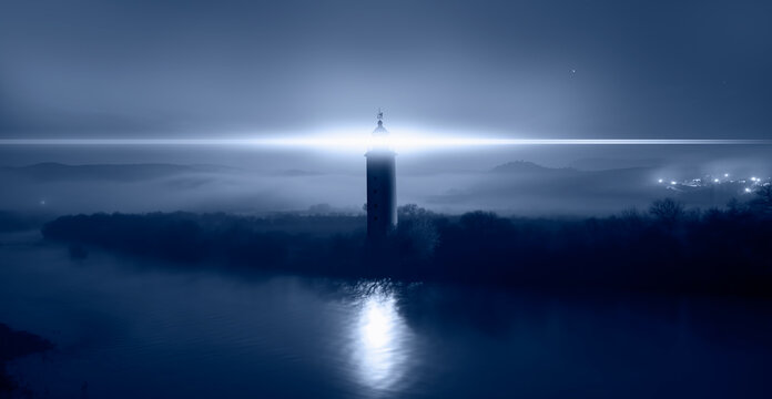 Night sky with lighthouse at dark night "Elements of this image furnished by NASA