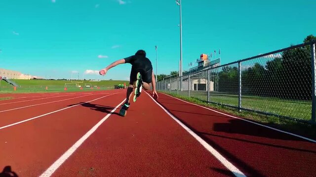 starting a race on rollerblades at a running track on a sunny day.