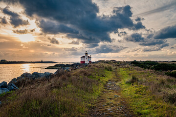 Fototapeta na wymiar Wide shot of Lighthouse in Bandon, Oregon Coast with dramatic clouds