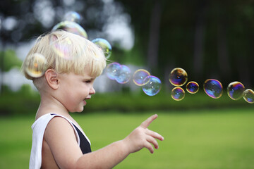 Little boy pointing at bubbles