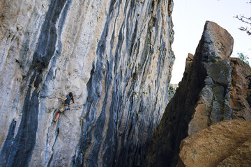 A strong girl climbs a rock, Rock climbing in Turkey.