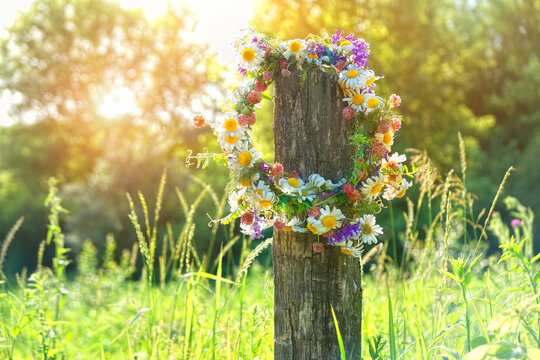 rustic wildflowers wreath. summer flower wreath in garden, sunny day. Farm lifestyle. Summer Solstice Day, Midsummer. floral traditional decor