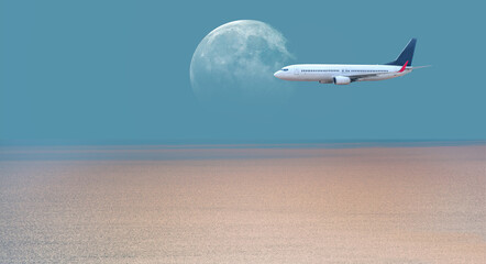 Fototapeta na wymiar Airplane flying above tropical sea at sunset with full moon 