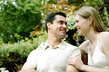 Fototapeta premium Couple smiling while looking at each other