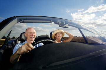 Senior couple traveling in the car