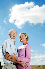 Senior couple smiling while hugging