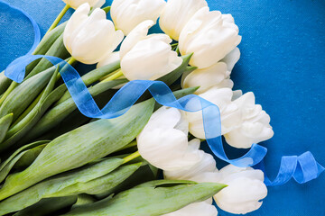greeting card. A large bouquet of white tulips on a blue background. congratulation. invitation. flat lay