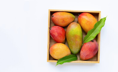 Tropical fruit, Mango in wooden box on white background.