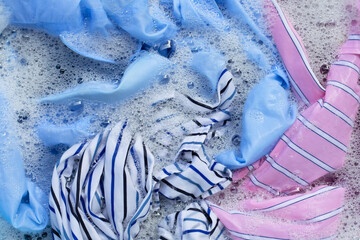 Color clothes soak in powder detergent water dissolution. Laundry concept