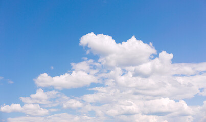 White clouds on blue sky background.