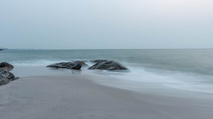 beautiful coastal stones on the shore of the warm sea in summer