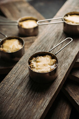 Julienne with chicken, cheese and mushrooms served in small metal bowl. Selective focus. Shallow depth of field.