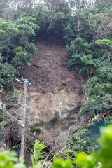 Landslide in Japan caused by heavy rain, a disaster where the cliff has collapsed onto the road close to local old people's houses.