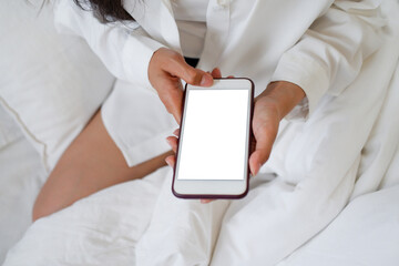 The woman works at home and wakes up in the bedroom with a mobile phone to check the job queue and...