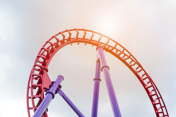 Roller coaster in the amusement park with the sunset background.