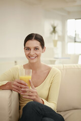 Obraz na płótnie Canvas Woman holding a glass of orange juice