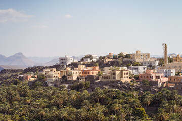 Fototapeta na wymiar scenic landscape view of Misfat al Abriyyin heritage village among palm trees in mountain
