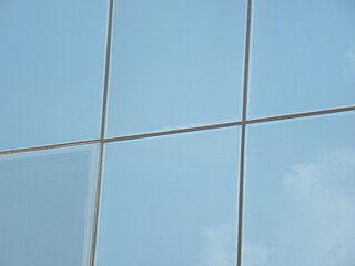Fototapeta premium Blue color steel and glass wall of building textured background