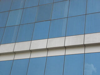 Blue and white color steel and glass wall of building textured background