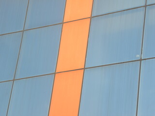 Blue and orange color steel and glass wall of building textured background