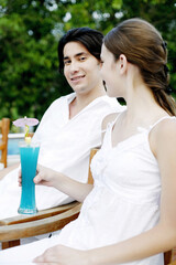 Couple relaxing by the pool side