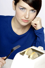 Woman holding a fork waiting for her toast