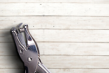 Hole punch on wooden table background