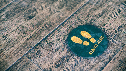 Stand here foot sign or symbol on the floor