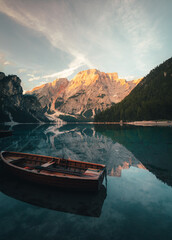 Fototapeta premium lake Braies (Lago di Braies) with sunlight on the mountain peak in Dolomites, Italy