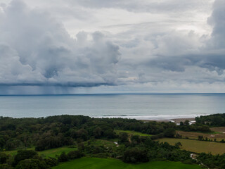 Fototapeta premium Beautiful aerial view of a Strong rain storm in the middle of the ocean, near the beach of Costa Rica