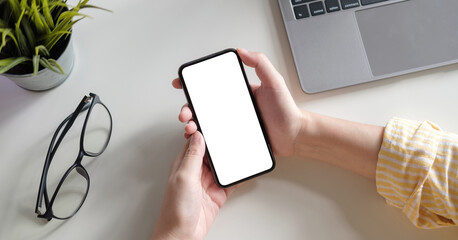 Top view Woman sitting and holding blank screen mock up mobile phone
