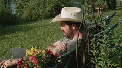man in cowbow hat relaxing in summer