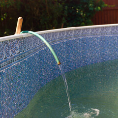 filling outdoor swimming pool with water
