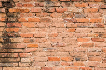 Surface old ancient orange brick wall pattern close-up.