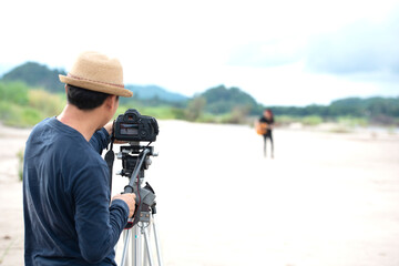Obraz premium vlogger recorded male songs related to the broadcast at White Sand Beach, Asia
