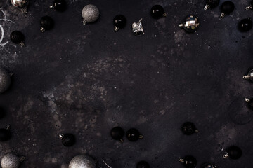 Christmas fir tree with decoration on dark board - Christmas Card with festive decoration over black background