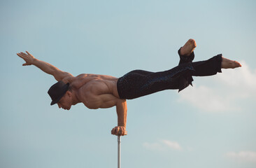 performance of an aerialist outdoors during sunset.