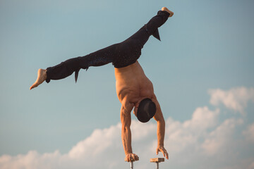 performance of an aerialist outdoors during sunset.