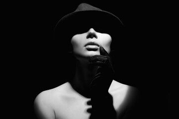 Beautiful woman in hat and gloves. Black and white portrait