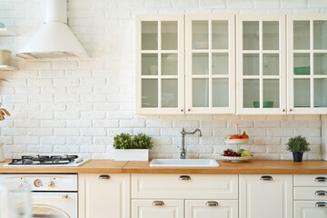 Fototapeta na wymiar Kitchen interior with kitchen utensils and kitchen stove. Scandi style.