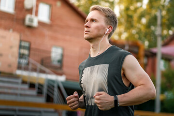 Athletic young man running on sunny day, space for text