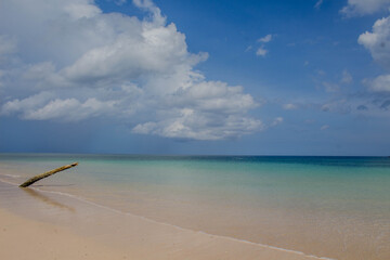 tropical beach with blue sky and clouds