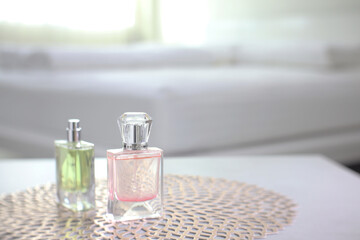 The luxury crystal spray glass of aroma body perfume put on the grey marble stone table in the bed...